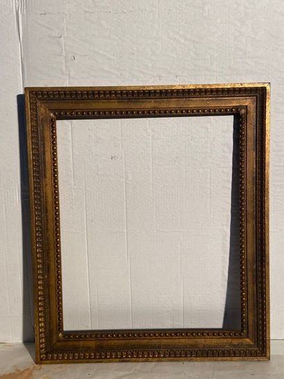 Wooden frame with gilded patina and rais-de-perles...