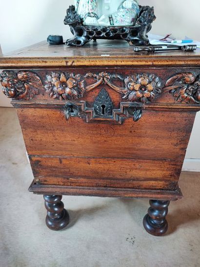 null Walnut chest with carved floral decoration. Partly from the XVIIth century....