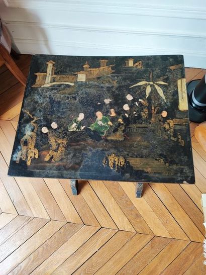 null 
Pedestal table lacquered black and gold with characters.




We joined a black...