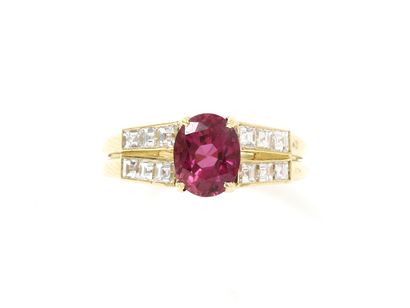 null Gold ring 750 thousandths, decorated with a faceted oval ruby in claw setting...