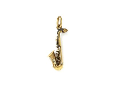null MELLERIO attributed to. Mini pendant 2 gold 750 thousandth stylizing a saxophone....