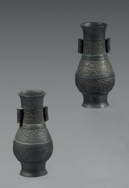 CHINE Two bronze "hu" vases with brown patina decorated with three alternating friezes...
