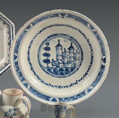 NEVERS Round earthenware dish, decorated in blue monochrome of a castle with two...