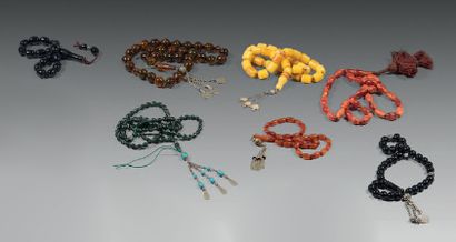 Seven mala, one of thirty-six amber beads,...