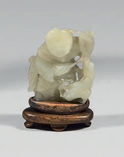CHINE Small celadon nephrite statuette of a standing child playing with a dog.
18th...