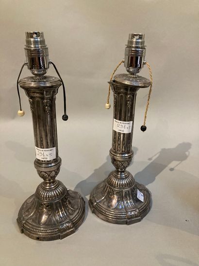 null Pair of silvered bronze candlesticks mounted in the Louis XVI style, decorated...