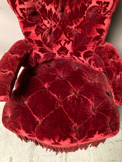 null Upholstered armchair with red velvet upholstery decorated with flowers, bangs....