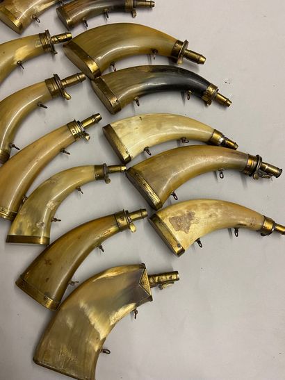 null 15 powder flasks in flattened cow horn with different types of spouts.