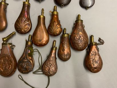 null 13 powder flasks in embossed copper with various decorations, a flask in horn,...