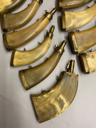 null 15 powder flasks in flattened cow horn with different types of spouts.