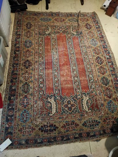 null Wool carpet with red background, decorated with three rectangular reserves in...