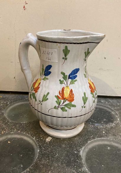 null An earthenware pitcher with small dimension with flowers. 

(small chips)