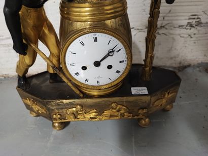 null Clock in gilt bronze, chased and patinated, representing an escalve carrying...