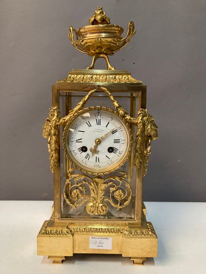 null Table clock in gilt bronze and glass case, decorated with lion muffles and flower...