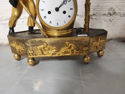 null Clock in gilt bronze, chased and patinated, representing an escalve carrying...