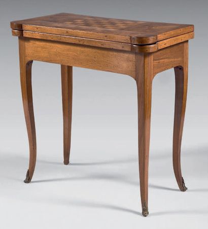 null Game table in walnut; the top inlaid with a chessboard framed by two reserves...