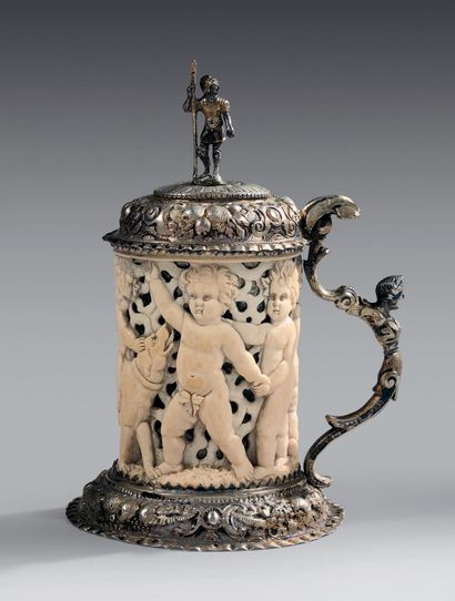 null Small tankard in ivory and silver embossed partially vermeillé; the lid with...