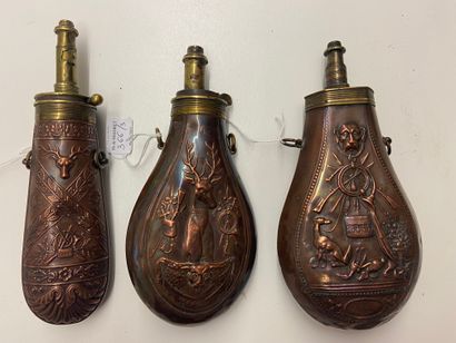 Three stamped copper powder flasks, decorated...