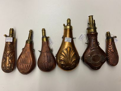 Six stamped copper powder flasks, decorated...