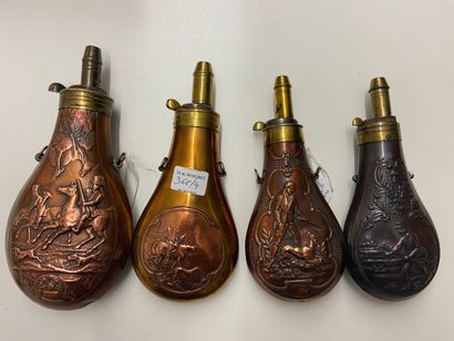 Four stamped copper powder flasks, decorated...