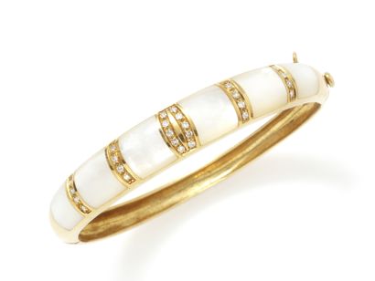 null Hinged gold bracelet with white mother-of-pearl motifs interspersed with lines...