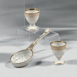 Paris, Manufacture de NAST Two egg cups and a sprinkling spoon in porcelain with...