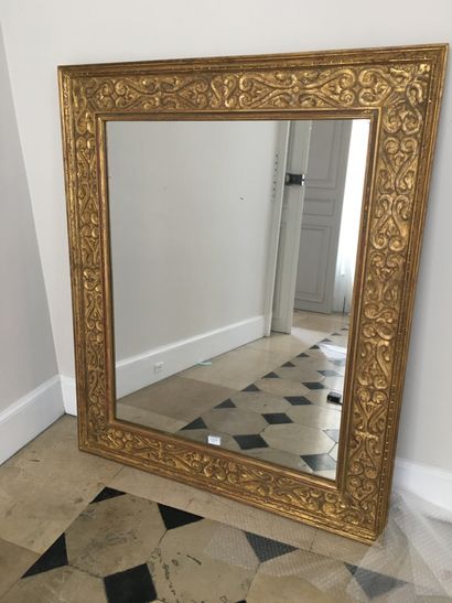Gilded wood mirror carved with staples and...