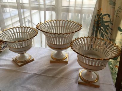 Three openwork porcelain cups on pedestal,...
