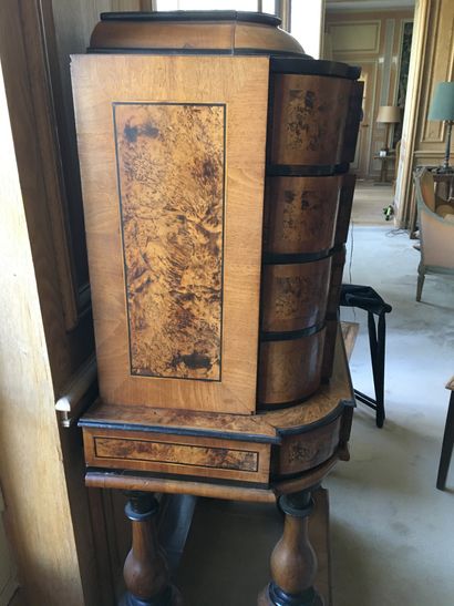 null A chest of drawers on a burl veneer base with blackened wood frames, opening...