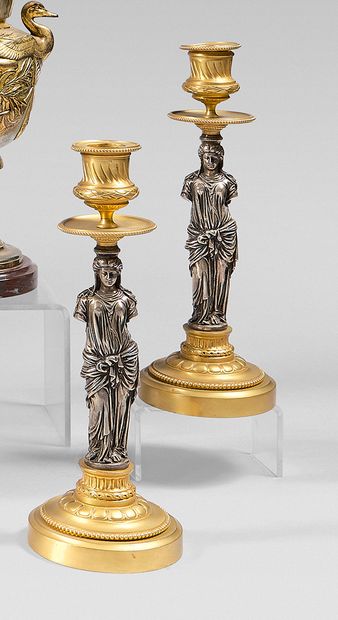 Pair of candlesticks in chased bronze, gilded...