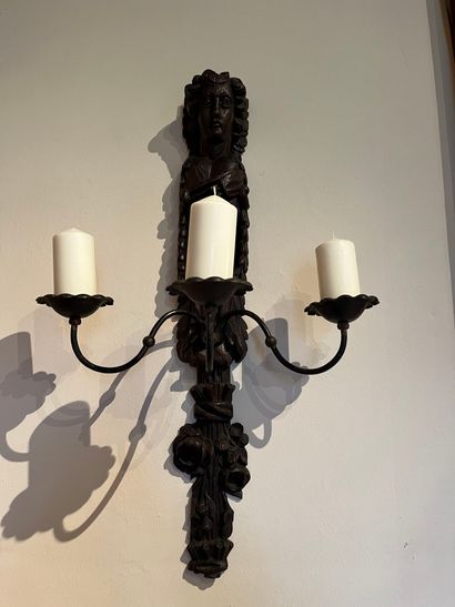null Pair of sconces in carved wood featuring a character above a bouquet of flowers...