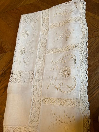 null Set of two tablecloths 
One in white cotton with openwork embroidery with floral...