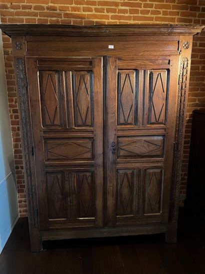 Oak cabinet molded and carved with rhombuses,...