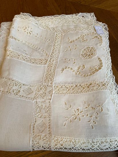 null Set of two tablecloths 
One in white cotton with openwork embroidery with floral...
