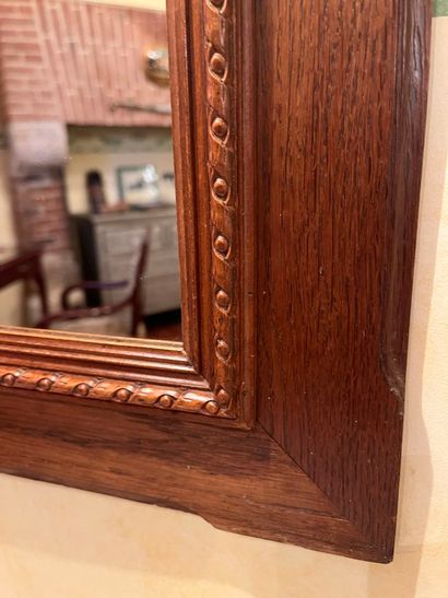 null Pair of framed mirrors in stained wood, carved decoration of ribbon.
66 x 56...