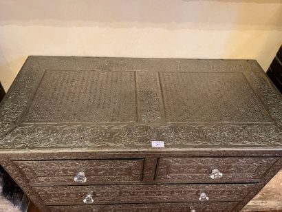null Wooden chest of drawers entirely covered with metal with embossed decoration....