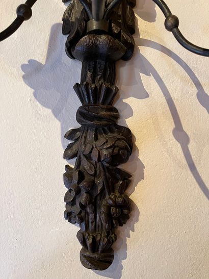 null Pair of sconces in carved wood featuring a character above a bouquet of flowers...