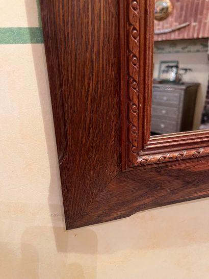 null Pair of framed mirrors in stained wood, carved decoration of ribbon.
66 x 56...