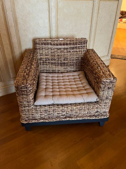Comfortable armchair and headboard in wicker...