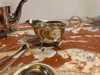 null Teapot, sugar bowl and milk jug in silver plated metal. Sugar tongs,
"Grand...