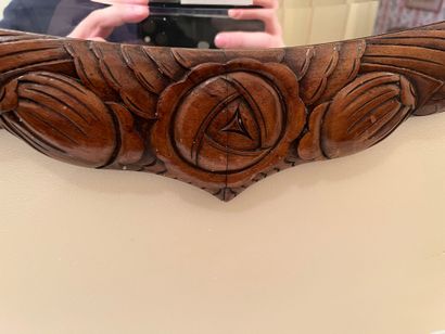 null Oval beveled mirror, wood frame carved with stylized flower buds. Art Deco....