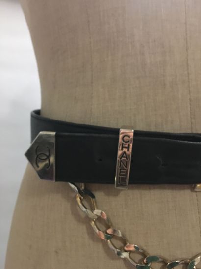 null CHANEL: Set of 2 black leather belts, one of which has a chain yoke with a logo....