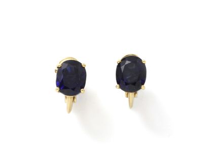 null Pair of 750 thousandths gold stud earrings set with claw-set faceted oval sapphires....