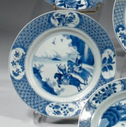 CHINE Assiette circulaire décorée en bleu sous couverte d'une scène animée de deux...