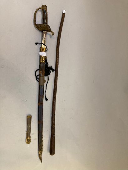 null Officer's saber with openwork hilt and marine scabbard.
A carved wooden cane...