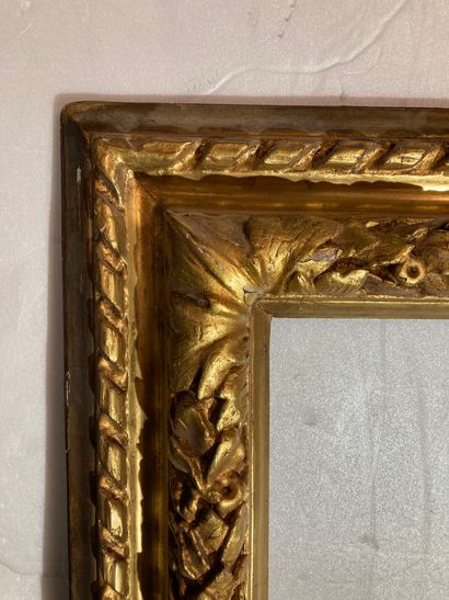 null A carved and redecorated wood frame with an upside-down profile, decorated with...