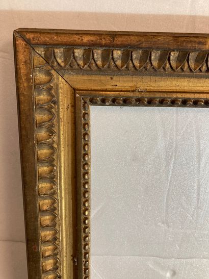 null A carved and gilded wood frame decorated with rais-de-perles and rais-de-cœurs,...