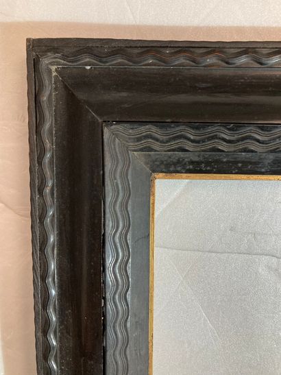 null A wood and ebony veneer frame with inverted profile and guilloché decoration,...