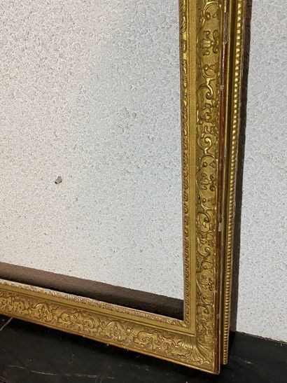 null A carved and gilded oak frame with sandblasted groove and Bérain decoration
Louis...