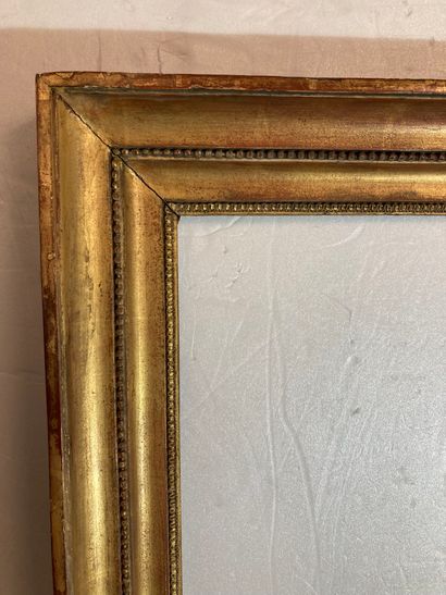 null A gilded wood and paste double-groove frame decorated with rais-de-cœurs and...